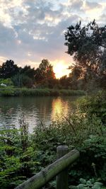 Scenic view of lake at sunset