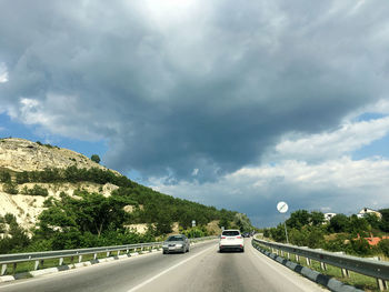 Cars on road against sky