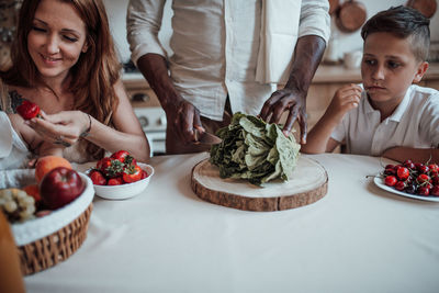 Happy friends sitting on table