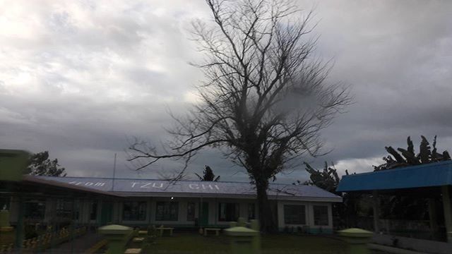 HOUSES AGAINST CLOUDY SKY