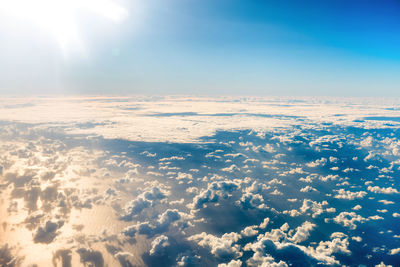 Beautiful airview with blue sky, white fluffy clouds and bright sunrays