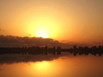 Scenic view of lake against orange sky