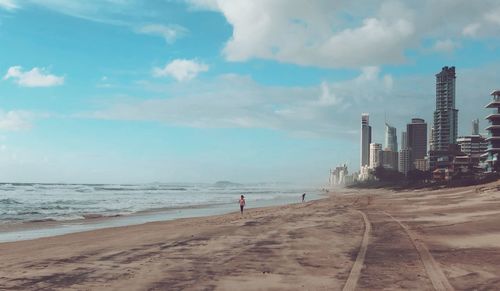 Scenic view of beach against cloudy sky