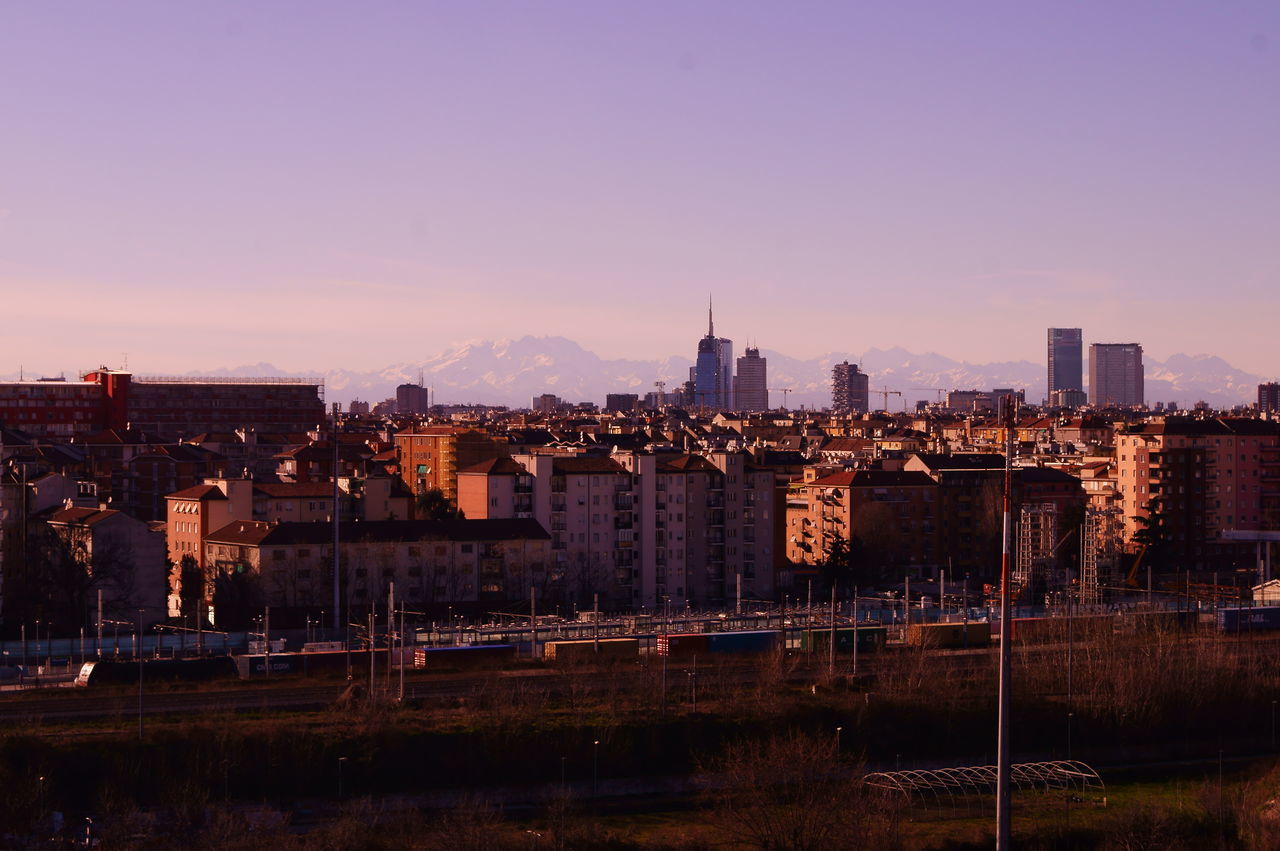 CITYSCAPE AGAINST SKY AT SUNSET