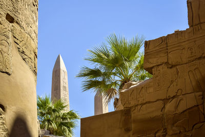 Ruins of karnak temple complex with columns carved with ancient hieroglyphs. luxor, egypt.