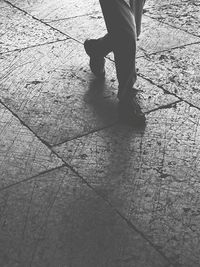 Low section of woman standing on tiled floor