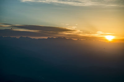 Scenic view of silhouette mountains against sky at sunset