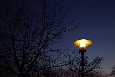 Low angle view of illuminated street light against sky at night