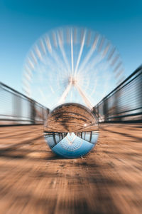 Close-up of crystal ball against blue sky