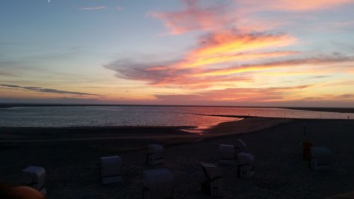 Scenic view of sea against orange sky