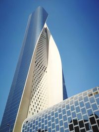 Low angle view of modern building against clear blue sky
