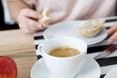 Close-up of hand holding coffee cup