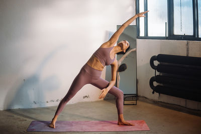 Low section of woman exercising on floor