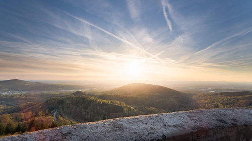 Sunset over the rhine plain. soft light and white sky streaked with condensation trails