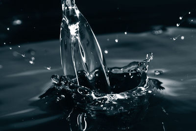 Close-up of water splashing against black background