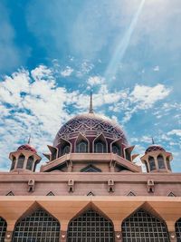 Low angle view of building against cloudy sky