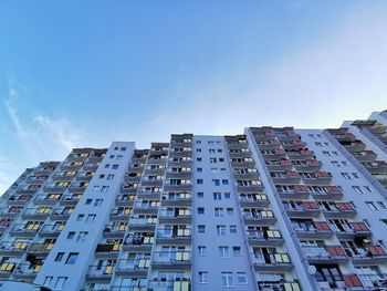 Low angle view of modern building against blue sky