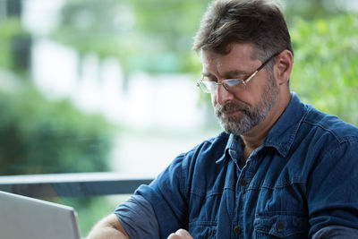 Mature man using laptop