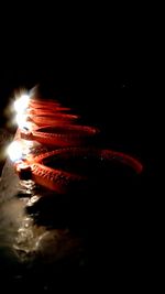 Close-up of illuminated lights against black background