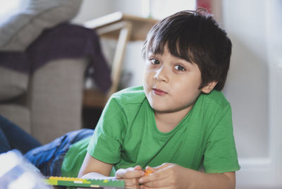 Portrait of cute boy sitting on table