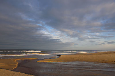 Scenic view of beach against sky during sunset