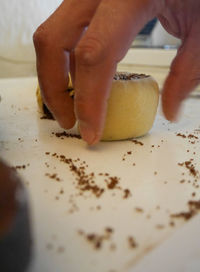 Close-up of person preparing food on table