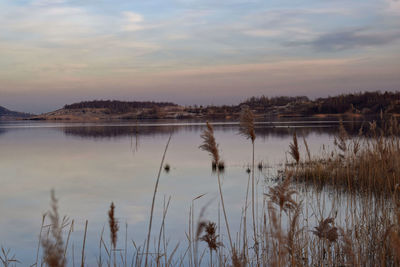 Scenic view of lake against sky during sunset