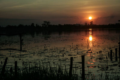 Scenic view of lake against sky during sunset