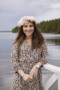 Smiling woman standing at lake