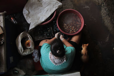 High angle view of woman sitting in container