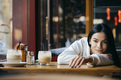 Portrait of smiling woman at restaurant table