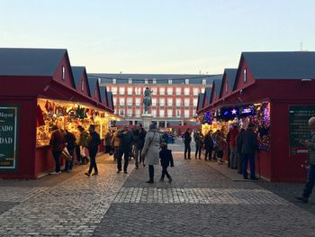 People at market against clear sky in city