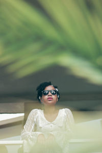 Portrait of young woman wearing sunglasses