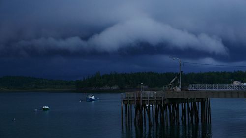 Scenic view of lake against storm clouds