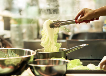 Cropped hand preparing food