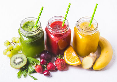 Selection of multicolored fruit smoothies in glass jars. healthy food detox concept