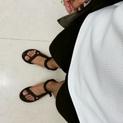 Low section of woman standing on tiled floor