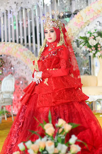 Midsection of woman standing with red umbrella