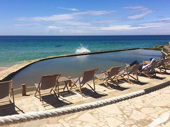 Scenic view of swimming pool by sea against sky