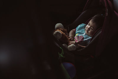 High angle view of baby girl sleeping in stroller