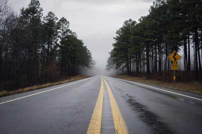 Empty road amidst trees