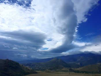 Scenic view of landscape against cloudy sky