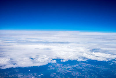 Aerial view of sea against blue sky