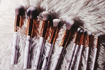 Close-up of make-up brushes on rug