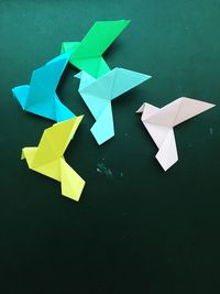 High angle view of colorful paper cranes on table