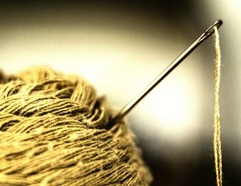 Close-up of sewing needle in wool