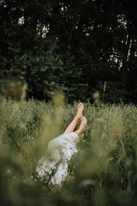 Midsection of woman on field