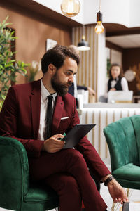 Young man using laptop while sitting at home