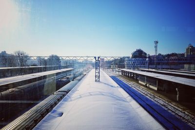 Bridge over canal against clear sky during winter