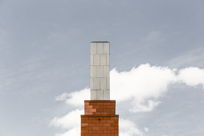 Low angle view of tower against cloudy sky